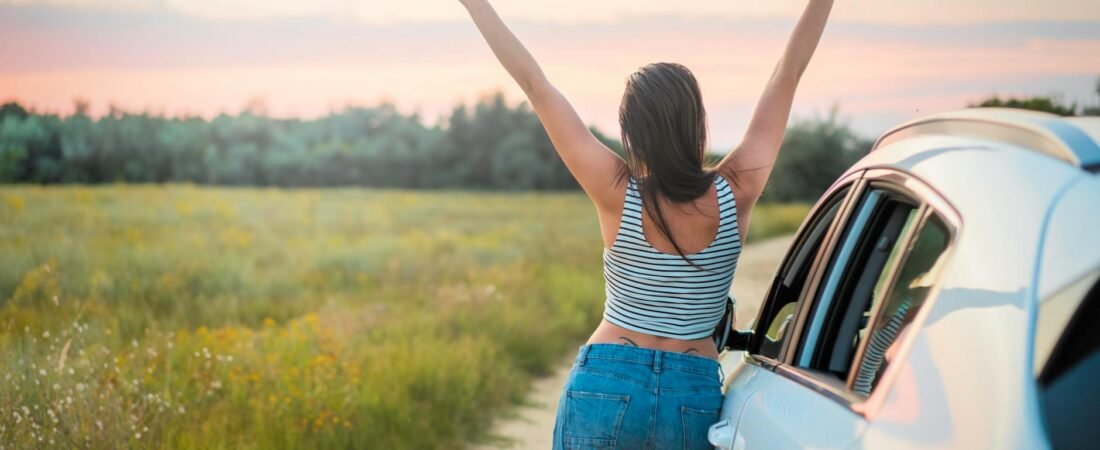 woman leaning beside vehicle