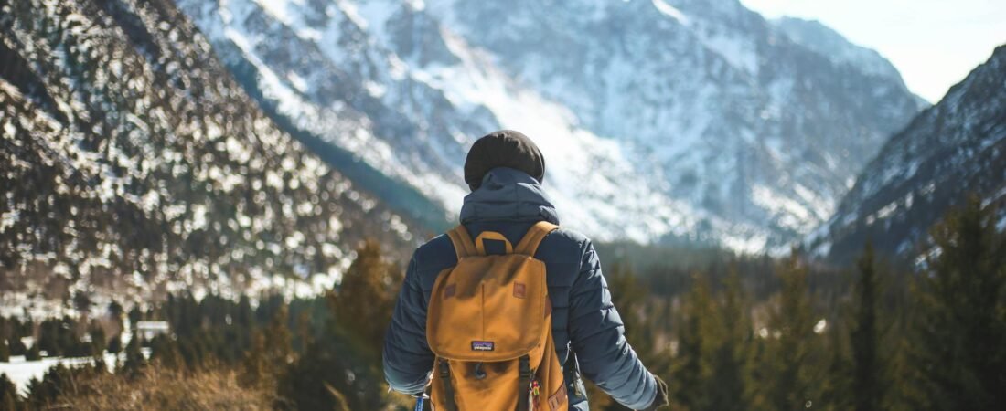 a man hiking and trekking with leather jacket and backpack