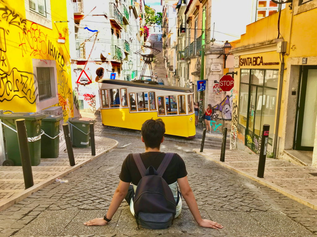 Backpacker looking at Street Car in Lisboa City, Portugal